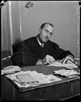 Judge Irvin Taplin looking over paperwork, Los Angeles, 1936
