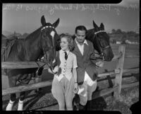 Mary Pickford and Buddy Rogers posing with horses at a ranch, Los Angeles, 1936