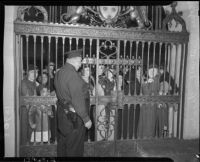 Policeman standing guard at the gates to John Joseph Cantwell's elevation to archbishop ceremony, Los Angeles, 1936