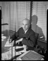 American artist Rockwell Kent at his desk, Los Angeles, 1937