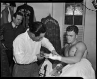 Boxer Bob Nestell getting his hand taped up before a fight, Los Angeles, 1937