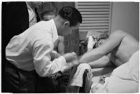 Boxer Bob Nestell getting his hand taped up before a fight, Los Angeles, 1937