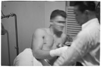 Boxer Bob Nestell getting his hand taped up before a fight, Los Angeles, 1937