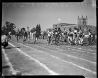 Track athletes pass batons in a relay event during the All-City High School track and field meet, Los Angeles, 1937