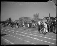 Track athletes race during the All-City High School track and field meet, Los Angeles, 1937