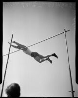 Track athlete participates in the high jump event during the All-City High School track and field meet, Los Angeles, 1937