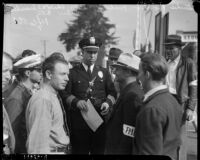 Culver City Chief of Police C.T. Truschel watches craft workers on strike at Metro-Goldwyn-Mayer studios, Culver City, 1937