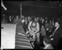 Wrestlers Bluebeard Lewis and Baron Benny Ginsberg grapple outside the ring, May 26, 1937