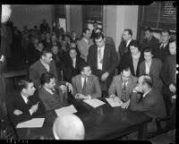 Attorneys, witnesses, and family members gather during the trial of Patrolman W.H. Redding who was accused of murdering longshoreman Norman Gregg, Los Angeles, 1937