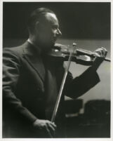 Zino Francescatti playing the violin, 1947 [descriptive]