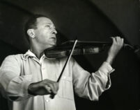 Jascha Heifetz playing the violin, 1957 [descriptive]