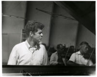 Van Cliburn with orchestra in background, 1958 [descriptive]