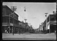 View of Sacramento Street showing a streetcar and rows of brick buildings with wooden porticos, Lodi, 1905