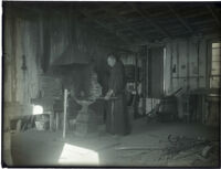 Monk forging in a blacksmith shop at the Mission Santa Barbara, Santa Barbara, 1898