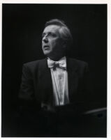 Walter Klien playing the piano in concert attire, 1986 [descriptive]