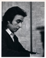 Santiago Rodriguez playing the piano, 1986 [descriptive]