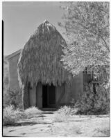 Bettye K. Cree studio, exterior view with a palapa shading a doorway, Palm Springs, 1929