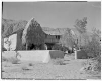Bettye K. Cree studio, view towards garden wall and studio exterior with a palapa against the side, Palm Springs, 1929