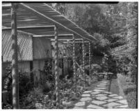Samuel A. Guiberson residence, view of narrow garden with stone path and pergola, Beverly Hills, 1938