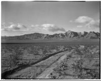 Unpaved desert road and mountains, Death Valley, 1927