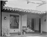 Leo V. Youngworth residence, view of porch with plants, chair, and poster, Baldwin Hills, 1932