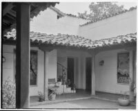 Leo V. Youngworth residence, view of porch with plants, chair, and posters, Baldwin Hills, 1932