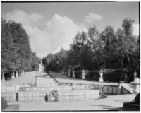 Gardens at the Royal Palace of La Granja de San Ildefonso, view of stairs leading up from a small pool and statue, San Ildefonso, Spain, 1929