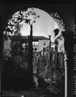 Court of la Acequia at the Palacio de Generalife, view through an arch towards a fountain and trees, Granada, Spain, 1929