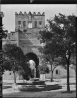 Patio de los Naranjos, view of a fountain and gateway in wall, Seville, Spain, 1929