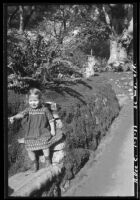 Rosita Dee Cornell walking in a garden, California, 1933