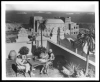 Vacationers on sunny terrace overlooking the coast of Southern California and fleet of ships, Long Beach 1933