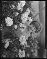 June Starr Carroll among roses, 1925