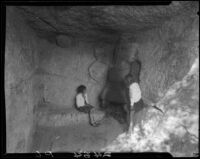 Interior view of cave with rock carvings, Los Angeles, 1930