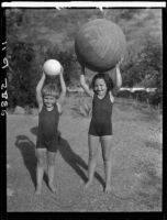 Two Estes children playing with exercise balls in a yard, [Van Nuys?], between 1928 and 1936