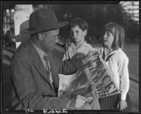 Veteran Leonard L. Deaver and two children with newspaper, Los Angeles, 1928 or 1930
