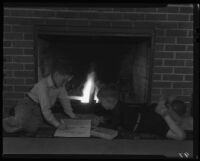 Boys writing in front of fireplace, Los Angeles, circa 1935