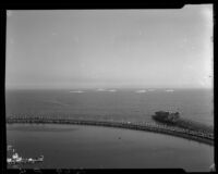 Birdseye view towards the rainbow pier and a fleet of ships in the ocean, Long Beach, 1932