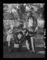 Eugene R. Plummer and girl with Indian artifacts, West Hollywood, 1927