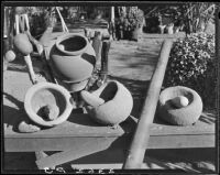 Grinding stones and Indian pottery at home of Eugene R. Plummer, West Hollywood, 1927