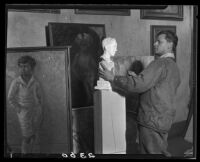 Otis Williams, in studio with sculpture and paintings, Los Angeles, 1927