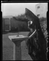 Woman standing at sundial, Harry Gorham residence, Santa Monica, 1928