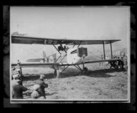Biplane and uniformed men, [1920s?]