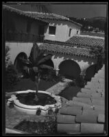 Bird's-eye view of courtyard and fountain of Spanish-style building