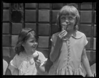 Two children eating ice cream cones from a concession at Abbot Kinney Pier, Venice, 1928