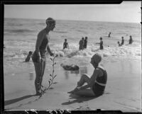 Edna Elliott and Daisey Howell on beach with seaweed, Pacific Palisades, 1927