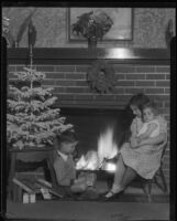 Children at fireplace with Christmas decorations, Los Angeles, circa 1935