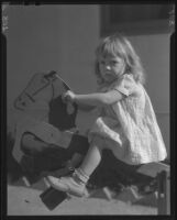 Girl riding wooden horse, Los Angeles, circa 1935