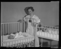 Nurse with babies in cribs, Los Angeles, circa 1935