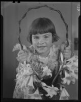 Girl with basket of Easter lilies, Los Angeles, circa 1935