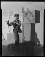 Boy on cardboard horse with toy bow and arrow, Los Angeles, circa 1935